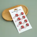 8-piece set of novelty red mushroom paper clips displayed on white cardboard backing - Set of 8 / Mushroom