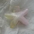 Close-up of a starfish-shaped hair claw clip with pink and yellow gradient marble effect - Smudged Starfish
