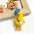 Cute yellow cartoon duck keychain featuring a blue hat and quirky backpack accessory - Backpack Duck
