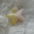 Close-up of a flower-shaped hair claw clip with pink and yellow gradient on tissue paper. - Smudged Starfish Small / S