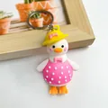 Adorable cartoon duck keychain accessory featuring a pink polka dot dress and a bright yellow sun hat - Butterfly Pink Duck