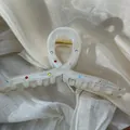 Close-up detail of white acetate shark hair clip with sparkling multi-colored rhinestones - 15CM Tassel Clip