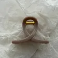 Close-up of jelly-textured hair claw clip in taupe with elegant butterfly loop design. - Jelly Medium Coffee
