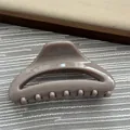 Macro detail view of a taupe minimalist glossy resin hair claw clip for hair styling - Dark Milk Tea