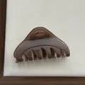 Detailed view of a semi-transparent brown triangle hair claw clip with strong grip - Fruit Coffee