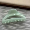 Detailed view of a mint green hair claw clip with a glossy finish for hair styling - Fruit Green