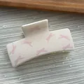 Macro view of a sweet cream square hair claw clip featuring pink bow and dot patterns - Cube Shape / L / Pink White