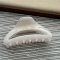 A detailed view showing the glossy cream translucent finish of this hair claw clip. - Fruit White