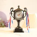 Creative trophy-shaped desk alarm clock in metallic finish with decorative ribbons - Silver