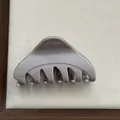 Detailed close-up of a minimalist taupe medium Korean triangle hair claw clip - Dark Milk Tea