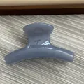 Close-up detail of a small jelly blue curved hair claw clip for elegant styling - Fruit Blue