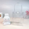 Clear PVC gift tote bag with a white button fastener for small gift packaging. - Transparent PVC Gift Bag (Without Light)