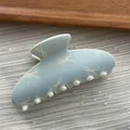 Macro detail view of a macaron blue hair claw clip with sweet white bow pattern style - Ingot Shape / L / Blue