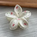 Close-up detail of a sweet cream flower hair claw clip with cherry and heart patterns - Flower / M / Cream White Heart
