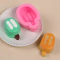 Detail view of pink popsicle silicone mold with green and orange handmade samples - Pink