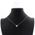 Detailed close-up of a minimalist moissanite solitaire necklace on a black display bust - 1 Carat Eight-Prong Style / Silver