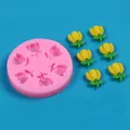 Detail view of tulip silicone mold with finished yellow flower decorations on blue background - Pink