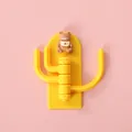 Cute yellow cactus wall hook featuring three rotating hooks and a small teddy bear - Teddy Bear