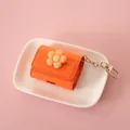 Premium orange AirPods case with cute flower charm and a sturdy gold keychain clip - Orange Flower - For AirPods 3/Pro / Orange