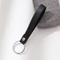 Elegant black leather strap keychain with silver metal ring, ideal for car keys and gifts. - Black