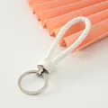 Close-up view of a minimalist white braided leather keychain strap with metal ring - White-Upgrade