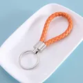 Hand-braided orange leather keychain with silver-tone metal ring for DIY accessories - Yellow