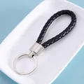 Elegant black braided leather keychain strap with a durable silver metal ring loop - Black