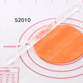 Acrylic embossed rolling pin creating intricate leaf patterns on orange fondant dough - Plant Cocoa Bean Texture (52010)