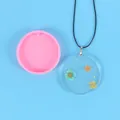 Round pink silicone resin mold for DIY flower pendant necklaces on blue background - Large Round Style (50-2115)