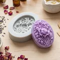 Detail view of oval rose flower silicone mold and its intricate floral relief cast. - Gray