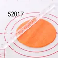 Detail view of acrylic rolling pin creating floral patterns on orange fondant - Petal Vine Pattern (52017)