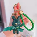 Porte-clés ours en résine vert avec dragonne en cuir tressé et ruban décoratif - Style Lapin Vert / Vert