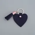 Porte-clés élégant en cuir noir en forme de cœur avec pompon tendance et anneau de couleur dorée - Frange de Cœur / Noir Cœur Gland