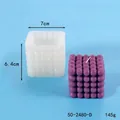 Silicone bubble cube candle mold with finished candle showing 7cm x 6.4cm dimensions - Rubiks Cube Bubble Style (50-2480-D)