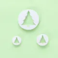 Set van drie witte plastic kerstboom fondant koekjesuitstekers op een lichtgroene achtergrond - 03060