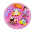 Detail of pink silicone mold showing various colorful toy-shaped fondant figures. - 50-35-A Pink