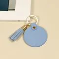 Porte-clés circulaire en cuir bleu clair avec pompon assorti et anneau doré - Glands ronds / Bleu Rond Gland