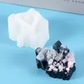 Detail of white silicone mold and finished resin crystal cluster on blue background - 60-683