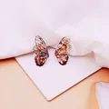 Detalle de elegantes pendientes de ala de cigarra con pan de oro y patrones blancos. - Estilo Ala de Cigarra Negra (Pan de Oro)