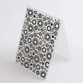 Close-up detail of a DIY plastic embossing folder featuring a black circle pattern design - Concentric Rings Pattern (56019)