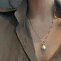 Elegant baroque freshwater pearl necklace with a vintage gold OT clasp box chain on model - Gold Box Chain Baroque Pearl OT Buckle Necklace (XL0852)