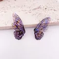 Primer plano macro de pendientes de ala de mariposa morada degradada con detalles de pan de oro - Estilo Ala de Cigarra Azul (Pan de Oro)