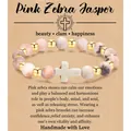 Handgemaakte roze zebra jaspis 8mm kralenarmband met wit kruisbedel op cadeaukaart - Pink Zebra Gold Beads