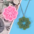 Detailed view showing a flower silicone mold beside its finished green resin pendant - Flower Style (50-2265-A) / Pink
