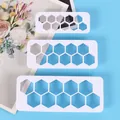 Close-up of three white hexagonal honeycomb geometric plastic cake cutters - Hexagon Style (72104) / Three-Piece Set