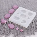Detail view of silicone mold with heart and diamond shapes and purple resin pendants. - Multi-Hole Teardrop Heart Style (50-1155-D) / 50-1155-D White