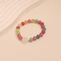 Close-up of colorful tourmaline beaded bracelet with a white carved flower charm - Chalcedony Flower Style