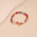 Close-up of colorful tourmaline crystal beaded bracelet with a golden Fu tag charm - Cat and Fortune Plaque Style