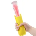 Vibrant yellow neoprene ice pop sleeve protector held by hand against white background. - Yellow
