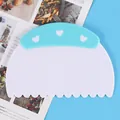 Plastic dough scraper with a light blue heart-patterned handle and scalloped edge detail - Boxed Wave Style (84066)